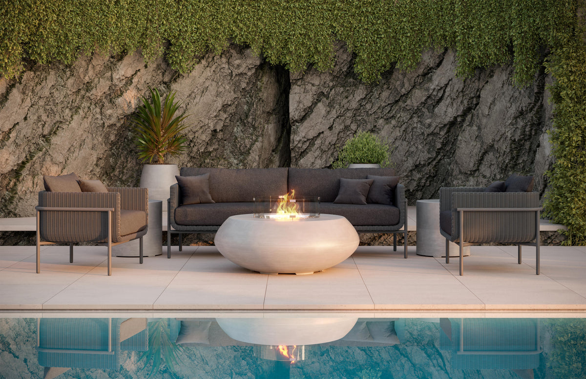 Hampton seating group around a fire table beside a pool